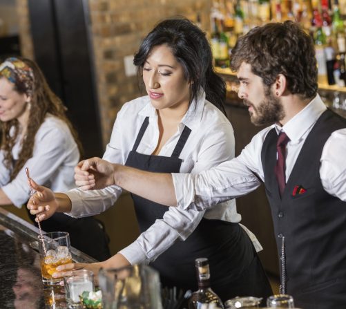 Formación de barman en 786-Bartend en Miami, aprendiendo técnicas de coctelería y habilidades de bar de un instructor.