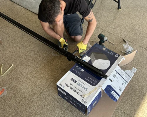 a carlos garage door technician working on a garage door opener