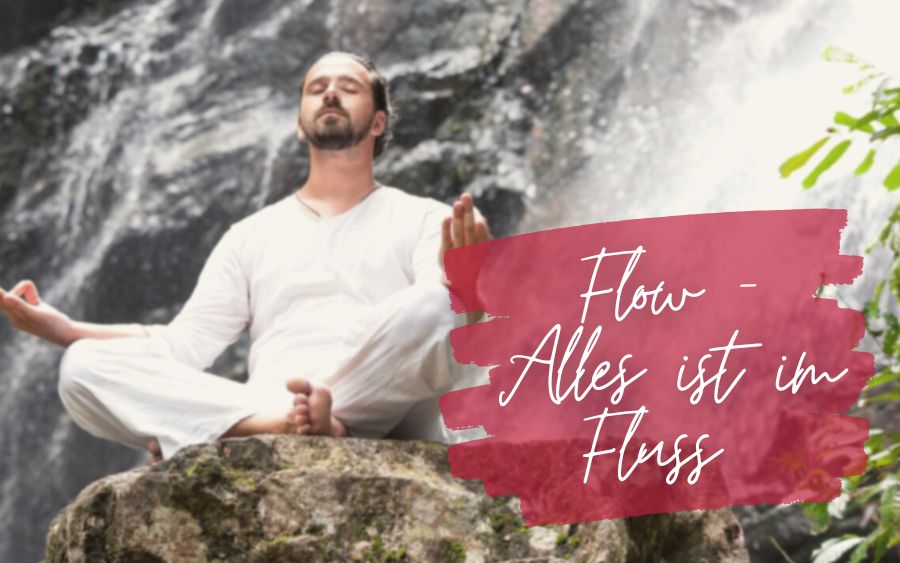 Man in meditation pose in front of a waterfall