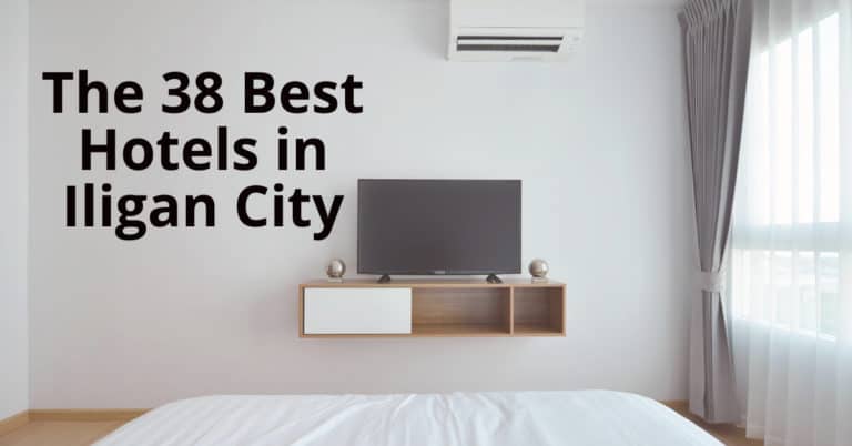 Minimalist hotel room na may TV, AC, puting bedding, at malaking bintana. Galugarin sa Iligan website para sa mga nangungunang hotel.