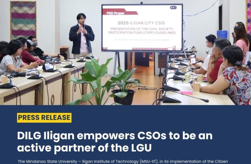a woman stands and speaks to a group seated in a conference room during a cso partnership meeting.