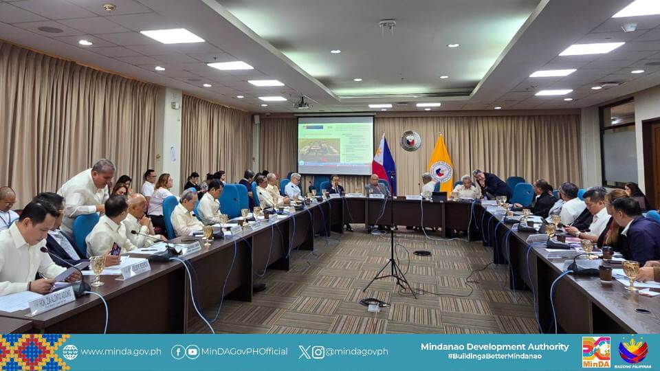 a large formal meeting on house bill 3595 is held in a conference room, with minda officials at a u shaped table.