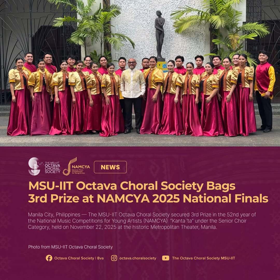 the msu iit octava choral society, mindanao pride, smiles in yellow and maroon before a statue at namcya nationals.