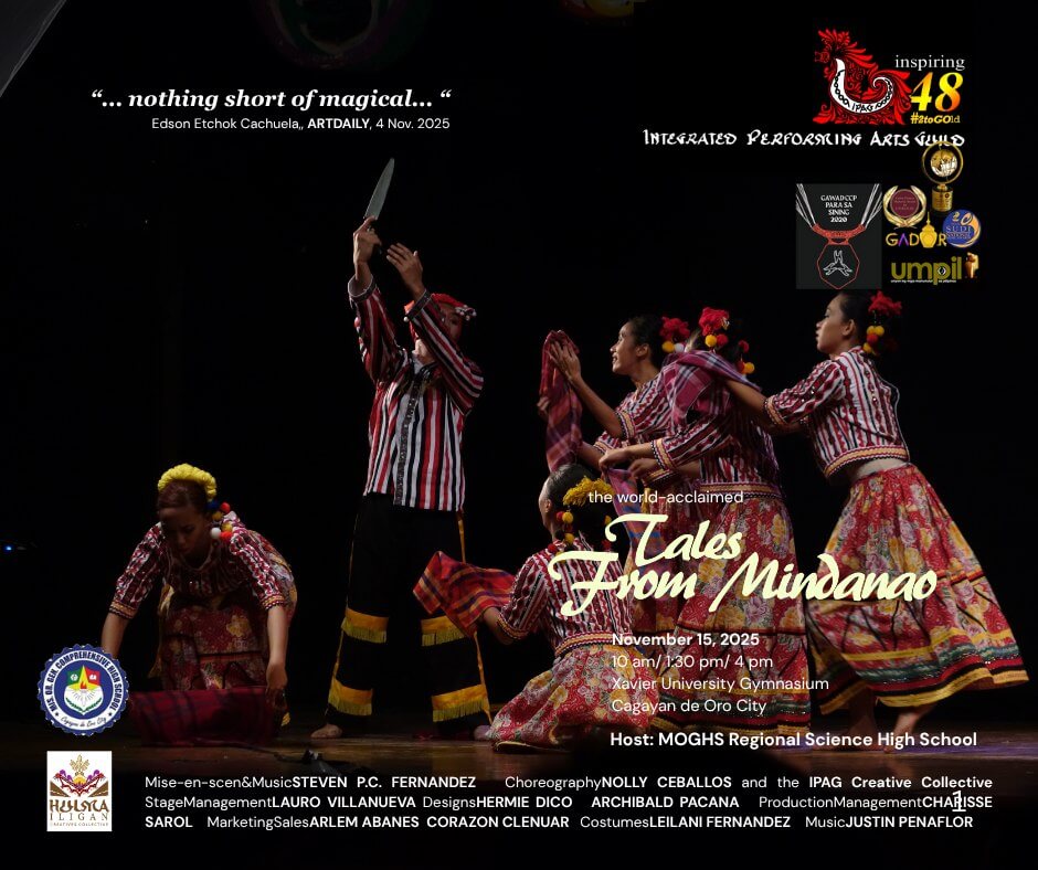 five dancers in colorful costumes perform with bamboo poles on a dark stage, mid movement, hands raised.