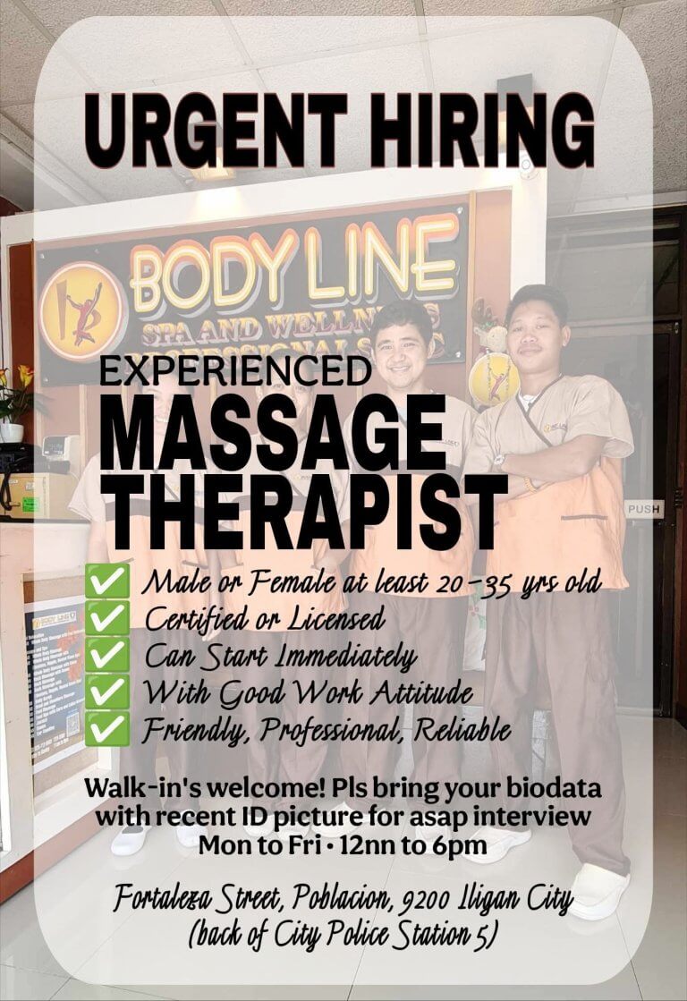 two smiling massage therapists stand in front of a body line spa sign, holding a “urgent hiring” notice.