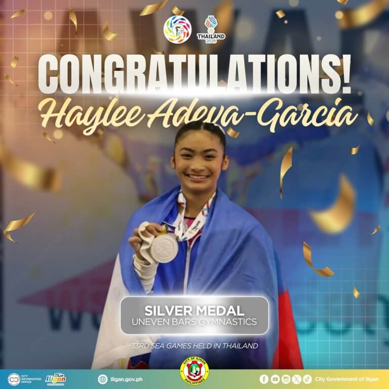 haylee adena garcia, iligan pride, smiles holding a silver medal and philippine flag at a gymnastics event.