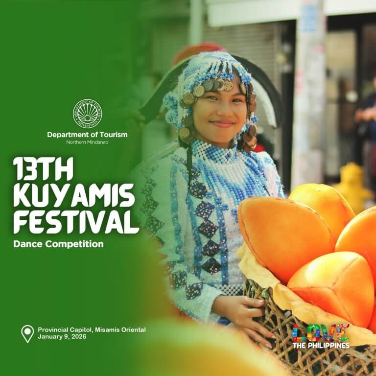a smiling woman in a beaded costume holds kuyamis fruits at misamis oriental’s vibrant kuyamis festival.