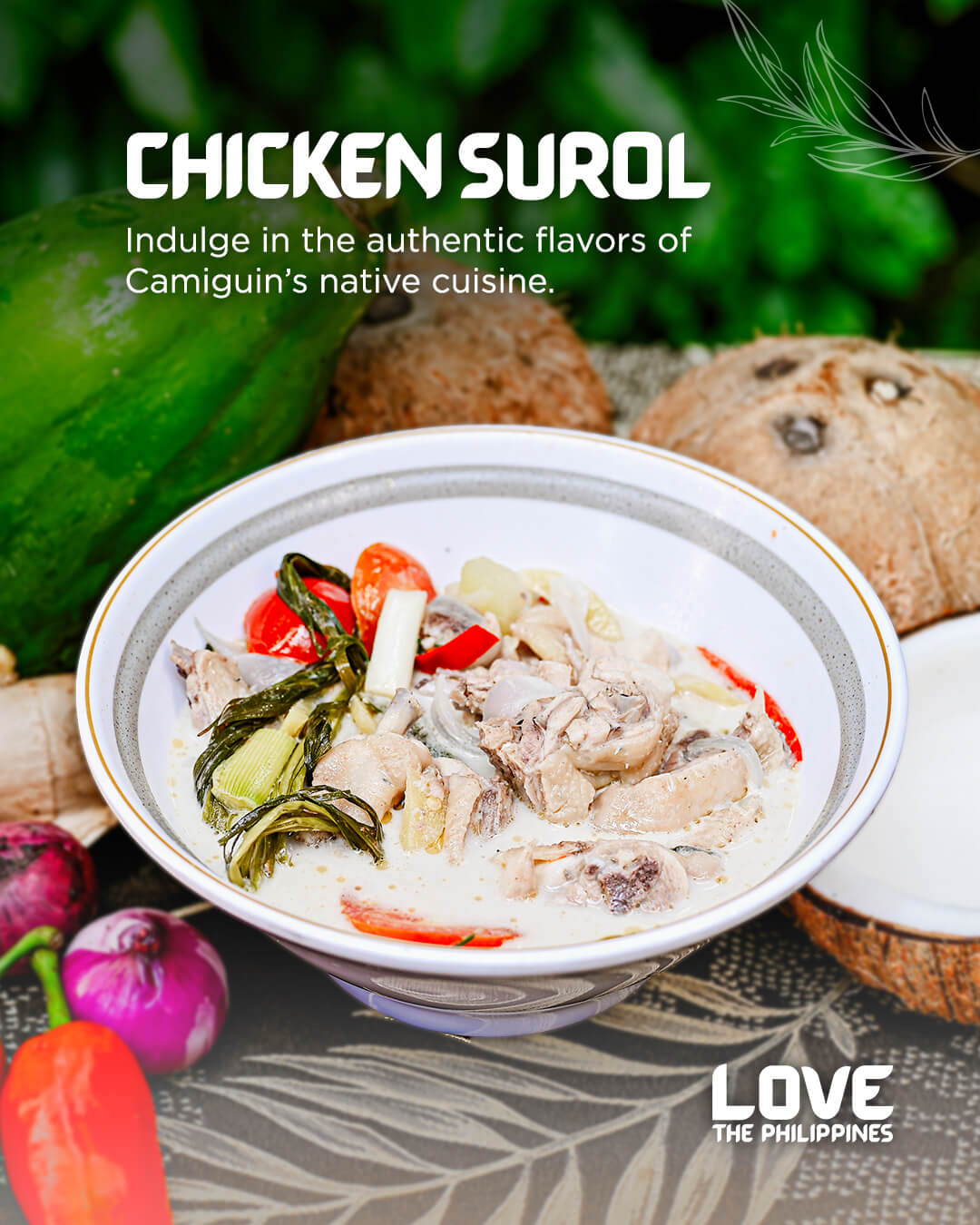 a bowl of chicken surol with coconut, vegetables, and spices, set on a table with native filipino ingredients.