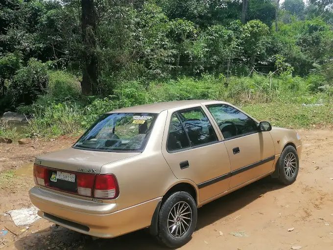 Tan sedan, under a