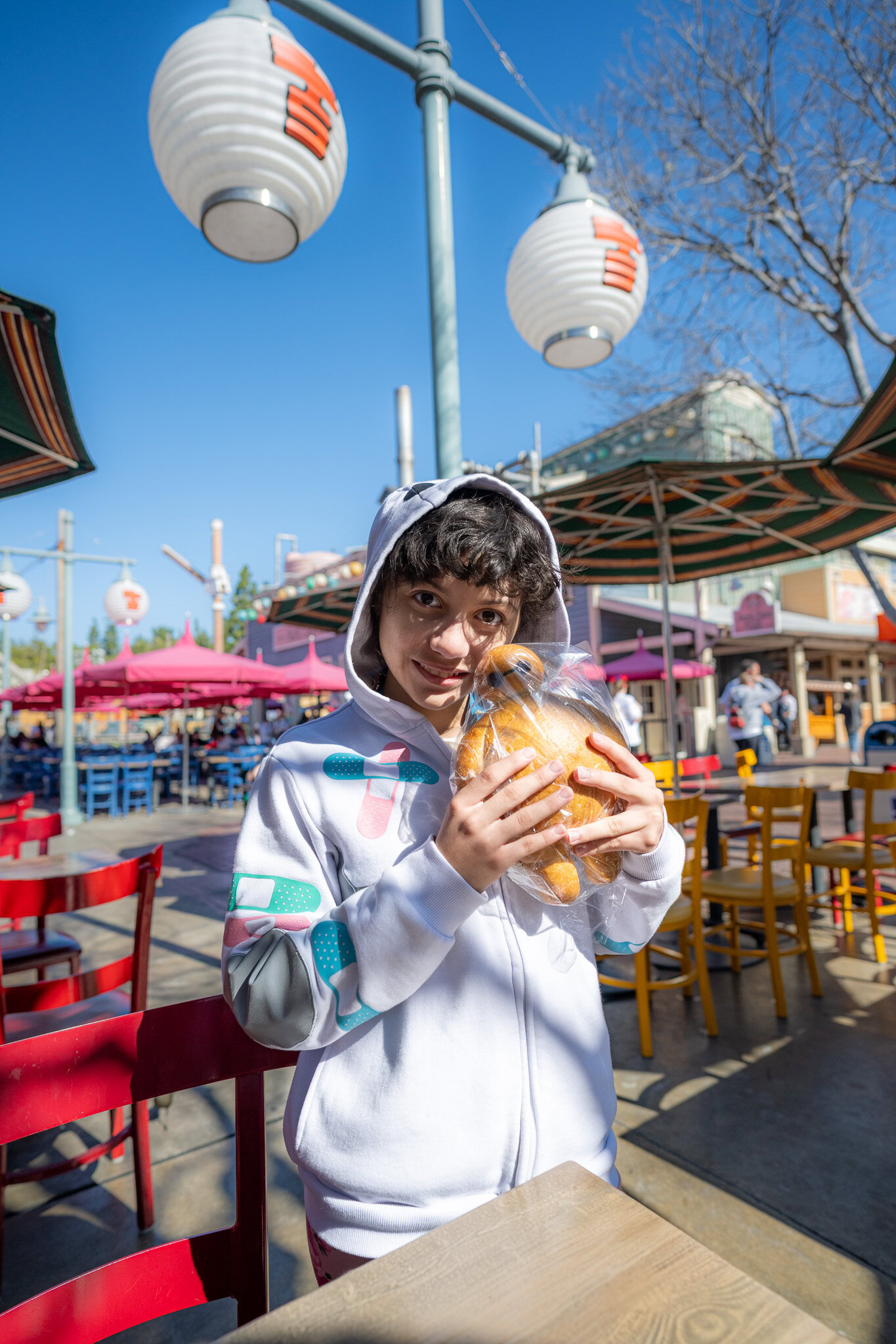 Daniela Colón holding a Baymax-shaped bread at San Fransokyo Square.