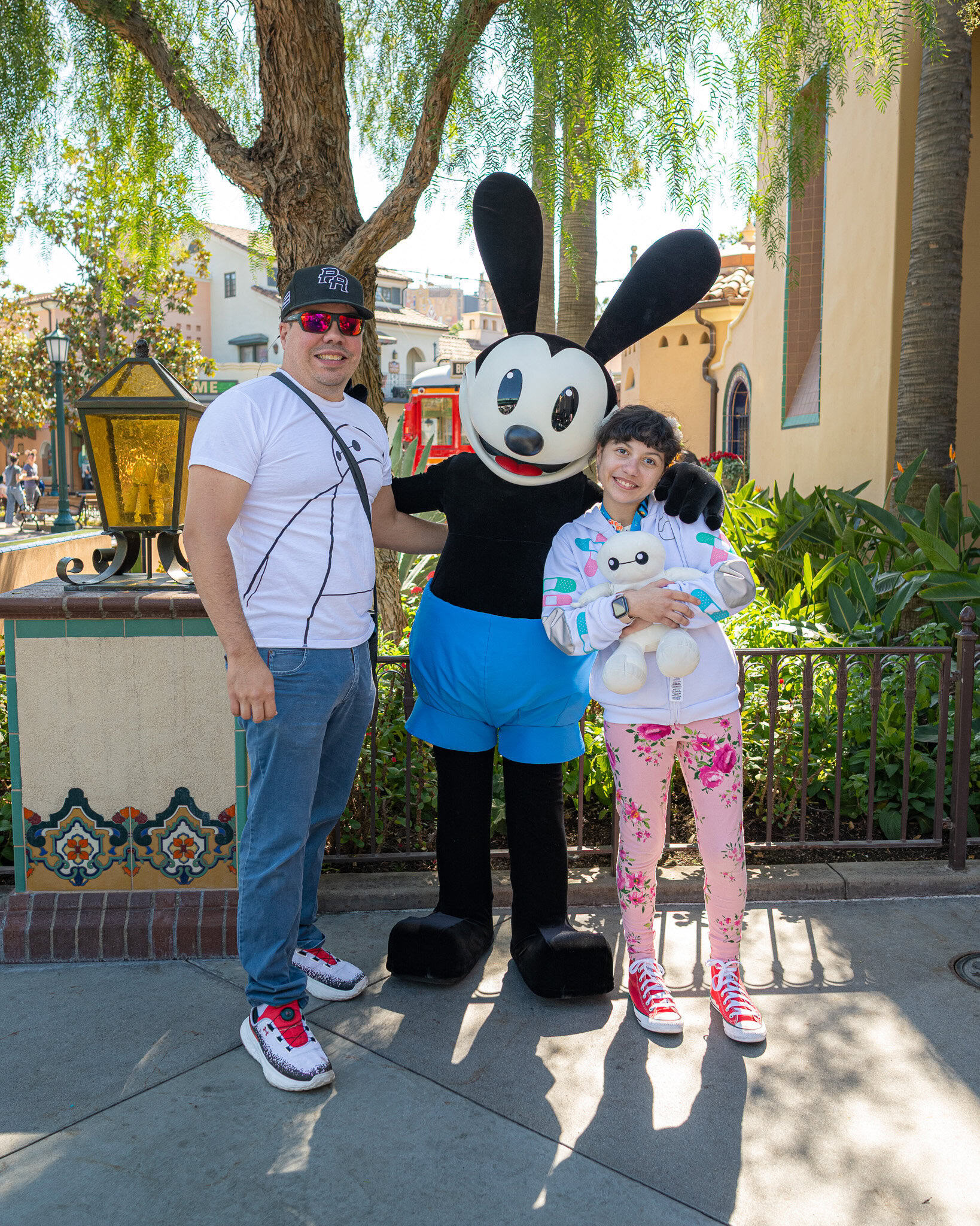 Raúl and Daniela Colón meet Oswald the Lucky Rabbit at Disney California Adventure