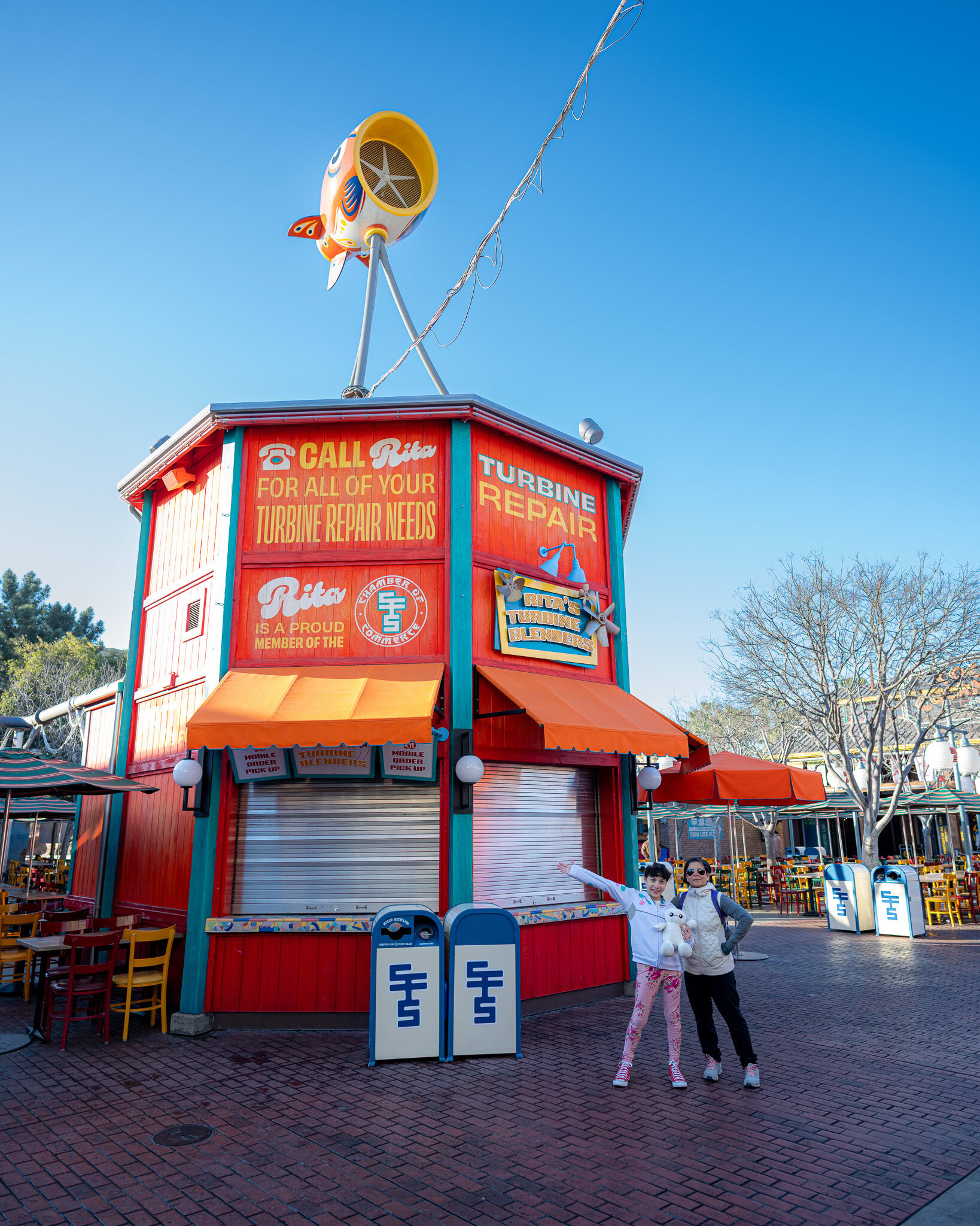 Daniela and Lucilla pose in front of Rita’s Turbine Blenders stand at San Fransokyo Square.