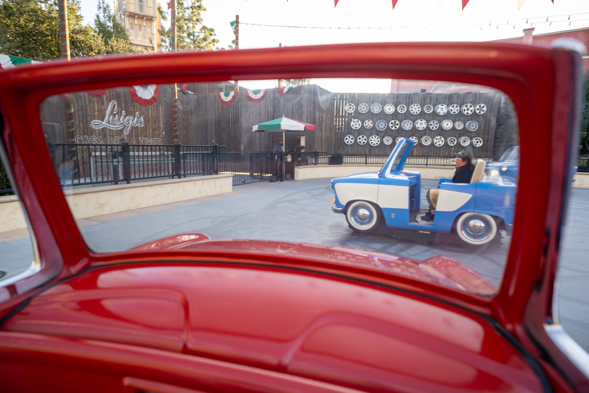 View of Luigi’s Rollickin’ Roadsters through a red car window.