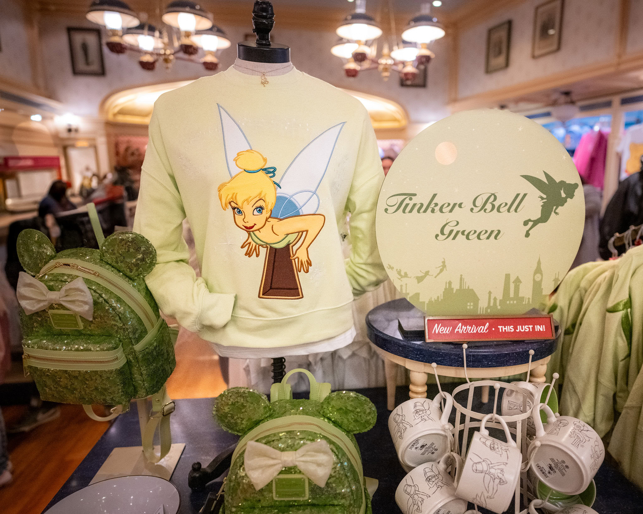 Tinker Bell, Loungefly backpacks, and mugs.