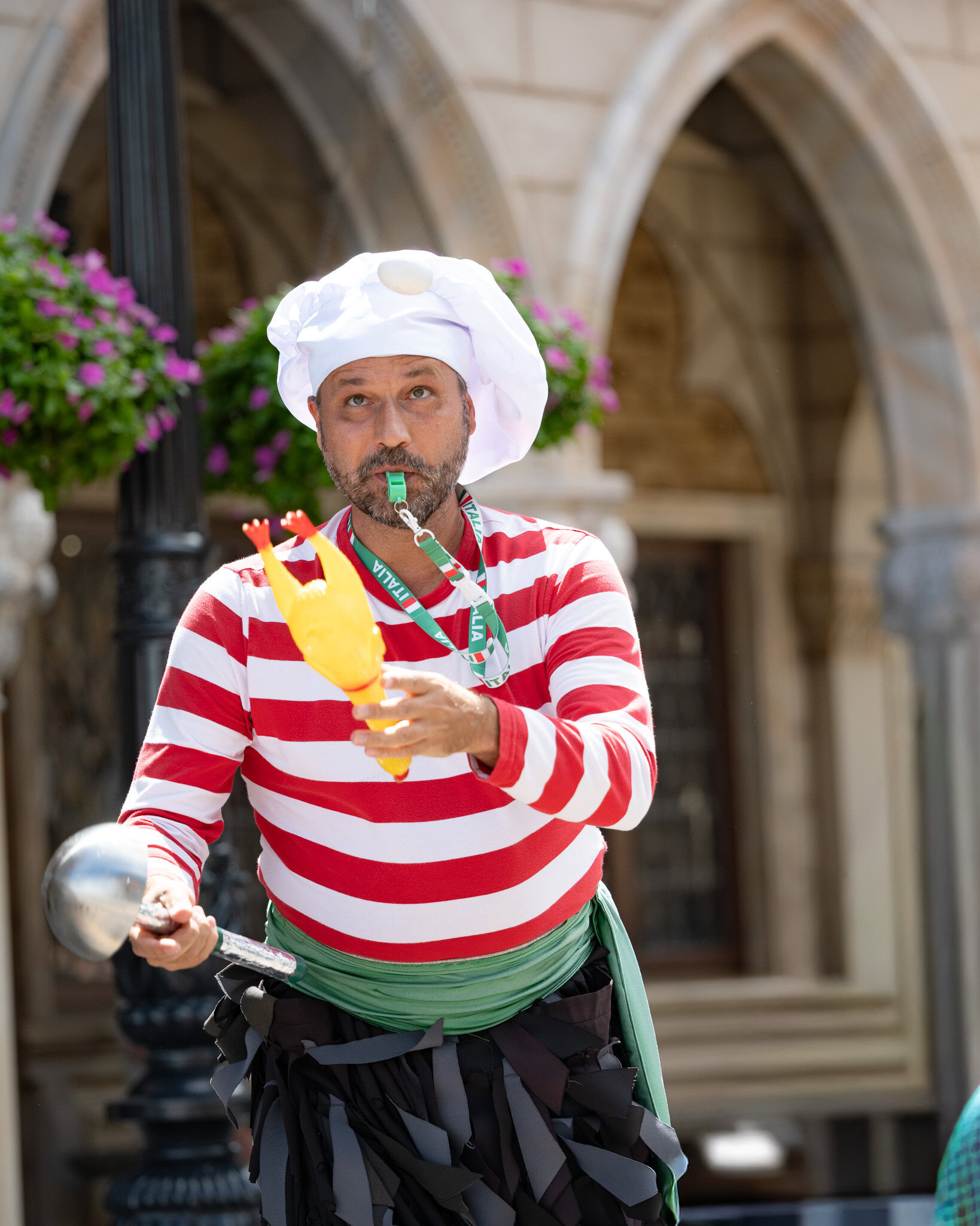 Street performer at EPCOT Italy Pavilion wearing a striped chef outfit