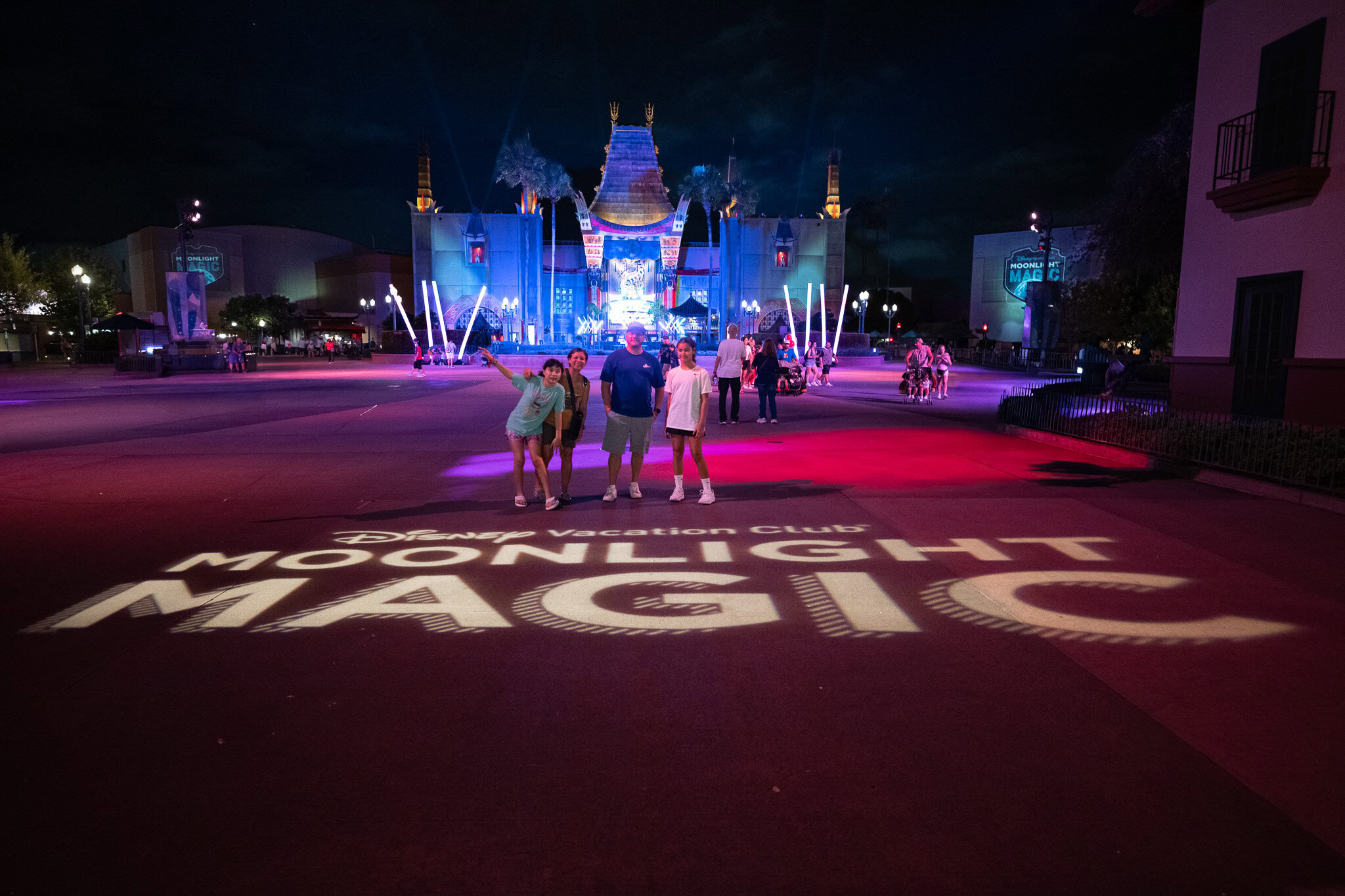 Laugh and Gear family standing in front of Moonlight Magic logo projection at Chinese Theater