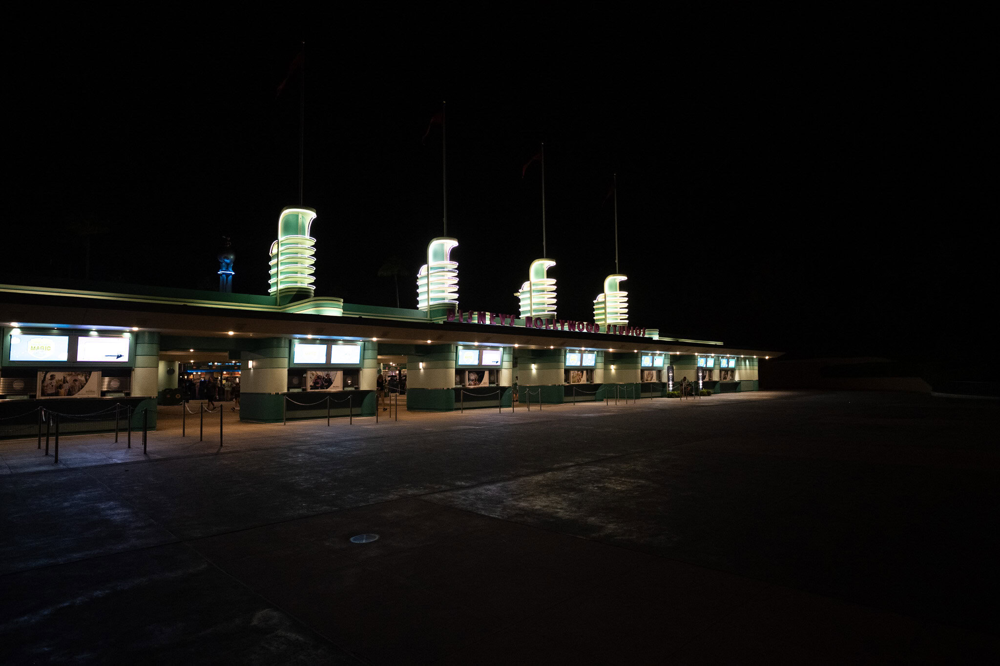 Entrance gates of Disney’s Hollywood Studios lit up at night for Moonlight Magic