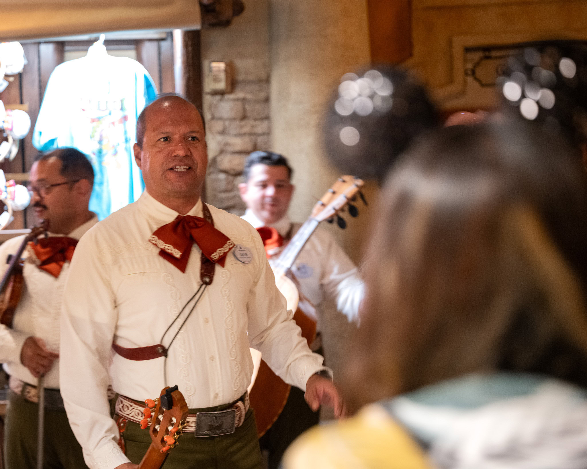 Mariachi Cobre performer at EPCOT Mexico Pavilion speaking to guests