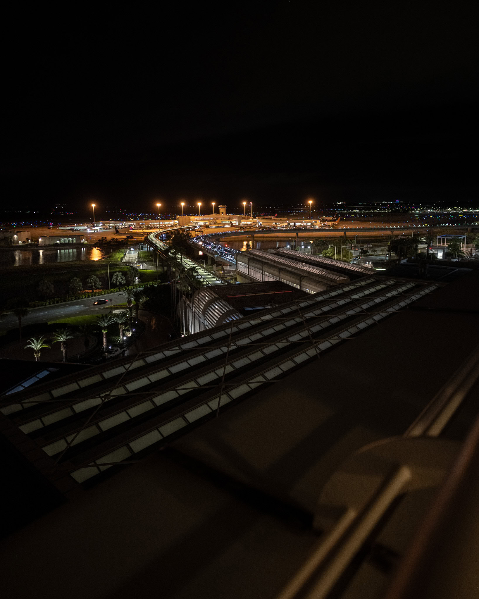 Aerial night view of Orlando airport tram system and terminal from Hyatt MCO