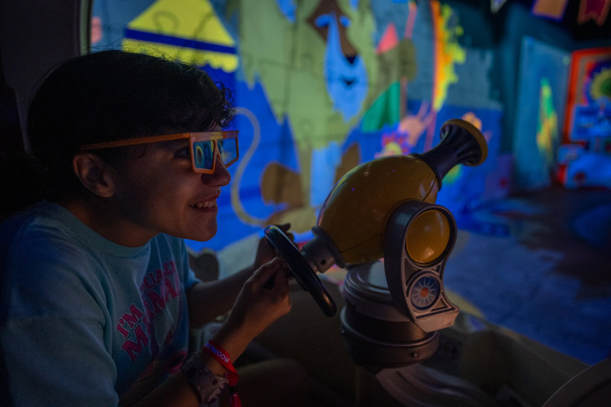 Girl aiming 3D blaster on Toy Story Mania ride at Hollywood Studios