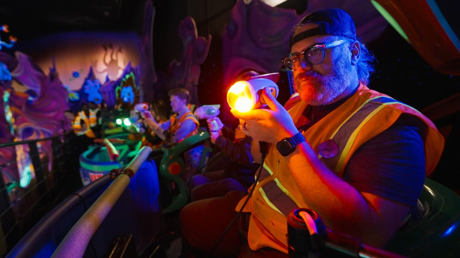Imagineers testing new handheld blasters during Buzz Lightyear ride upgrade.