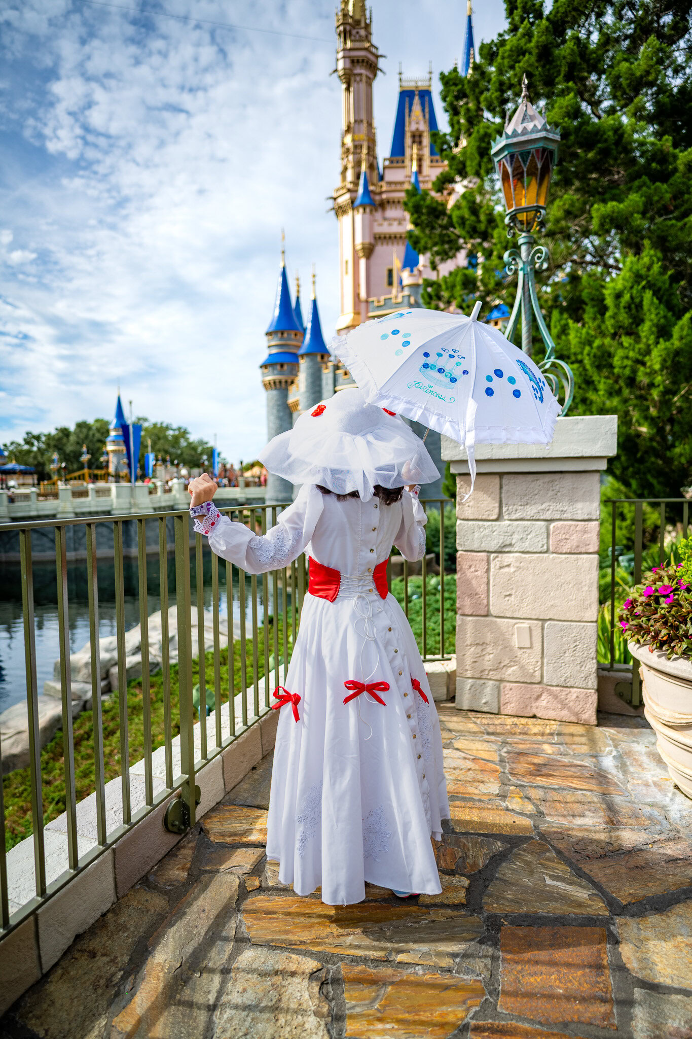 Girl dressed as Mary Poppins looking at Cinderella Castle in Magic Kingdom.