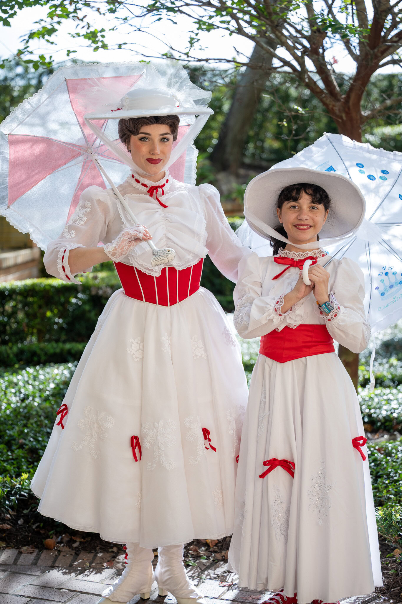 Girl dressed as Mary Poppins meeting Mary Poppins at Magic Kingdom entrance.