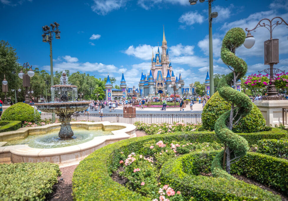 Cinderella Castle framed by gardens and a fountain in Magic Kingdom