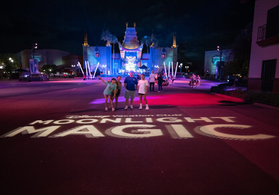 Laugh and Gear family standing in front of Moonlight Magic logo projection at Chinese Theater