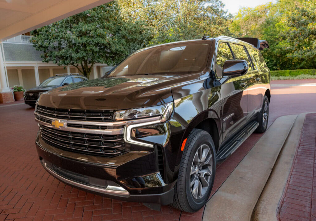 Black Chevrolet SUV from Gem Luxury Services parked at Disney's BoardWalk Resort entrance