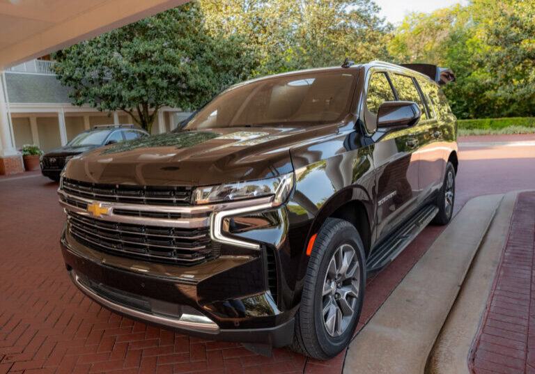 Black Chevrolet SUV from Gem Luxury Services parked at Disney's BoardWalk Resort entrance