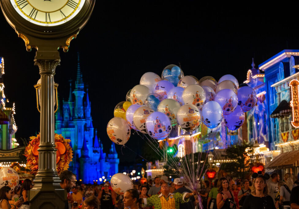 Clock tower and Halloween balloons on Main Street U.S.A. at night