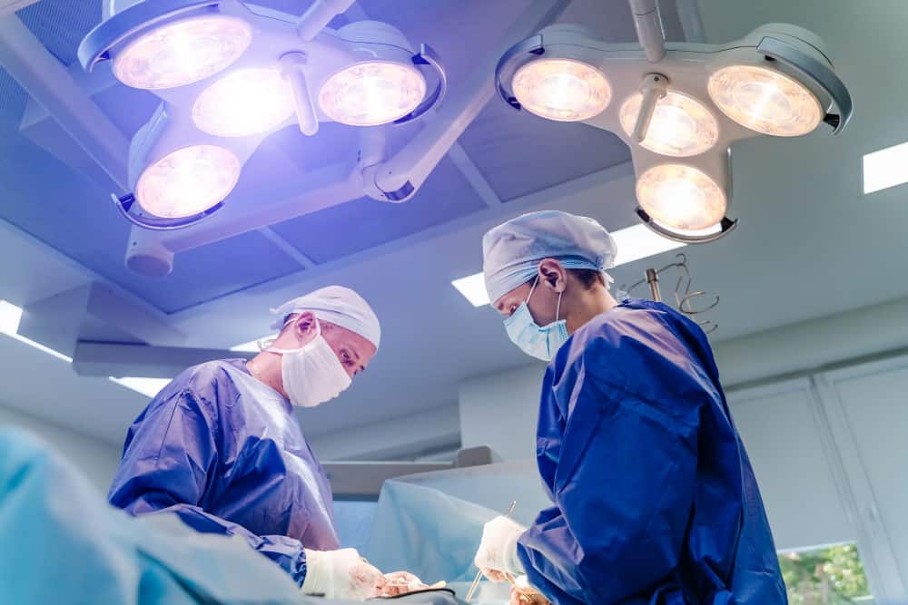 surgeons team is working surgical operating room health care concept