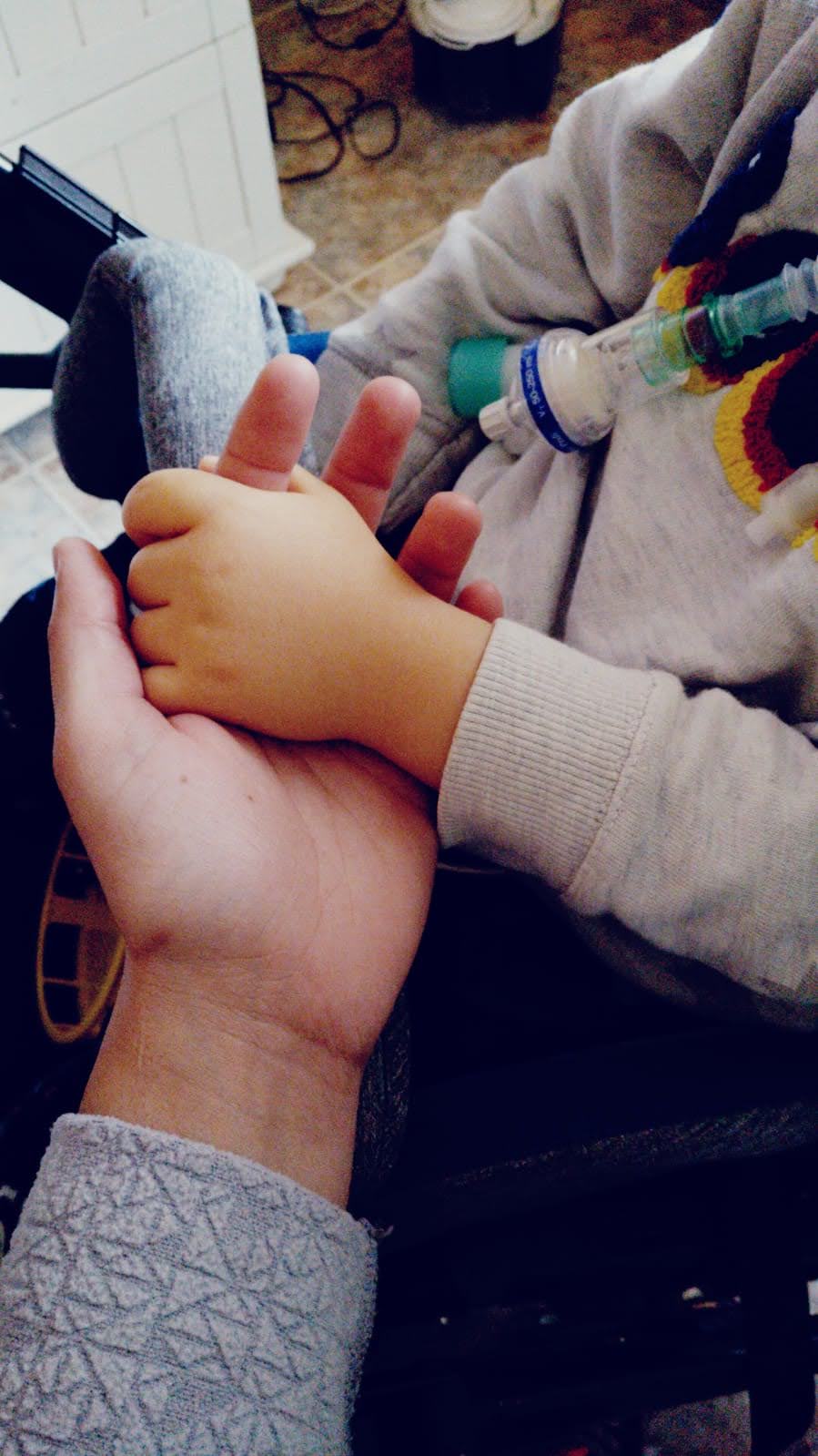 Child shaking hands to adult