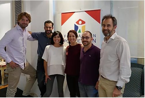 Paediatric palliative care Madrid Six smiling people from the paediatric palliative care team pose next to a poster of the CAPPI Foundation becauseThey live in Madrid. CAPPI Porque Viven Foundation