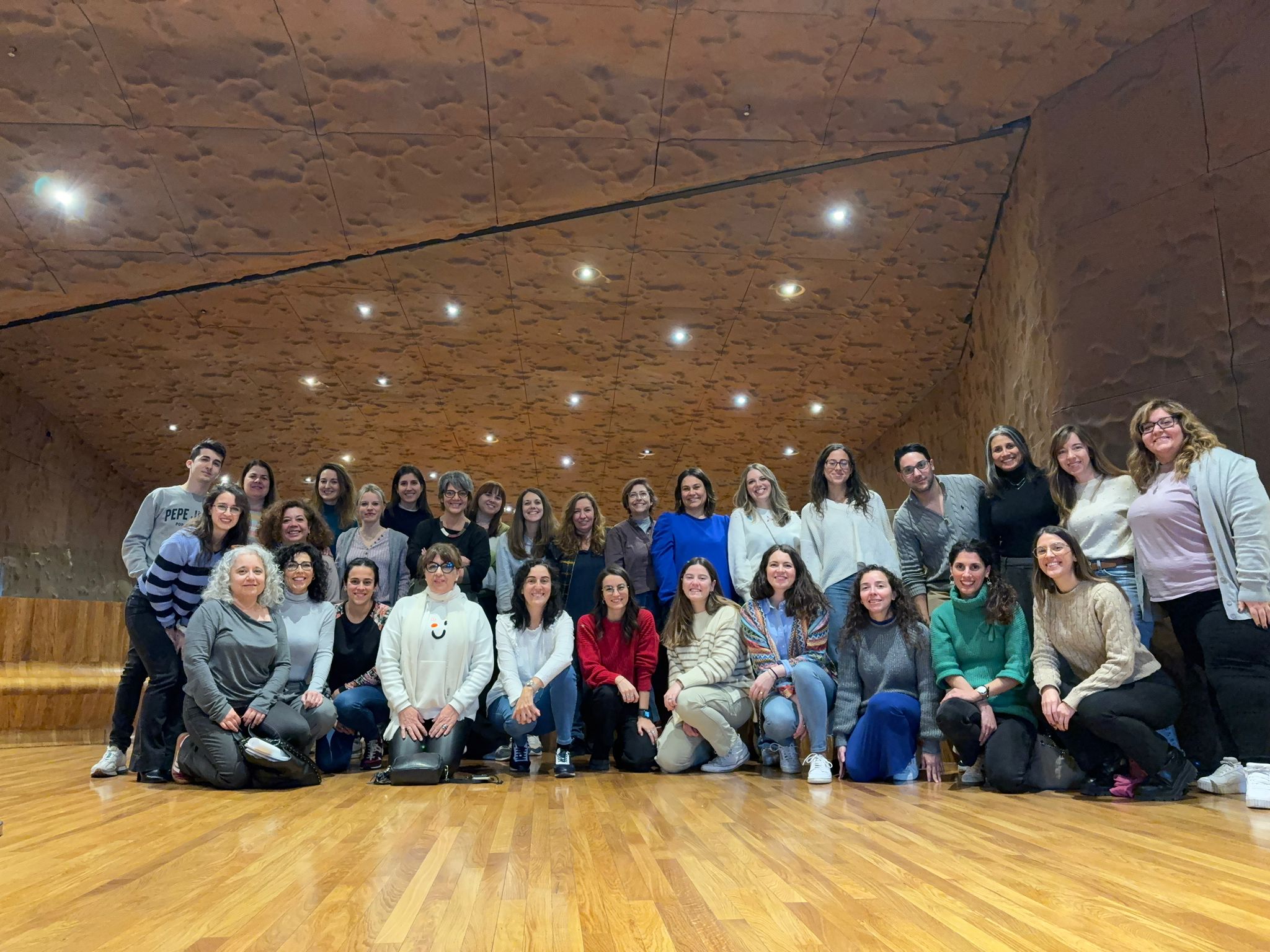 Pediatric Palliative Care Madrid Multidisciplinary team of CAPPI Foundation becauseThey live for pediatric palliative care in Madrid smiles together in a modern room. CAPPI Porque Viven Foundation