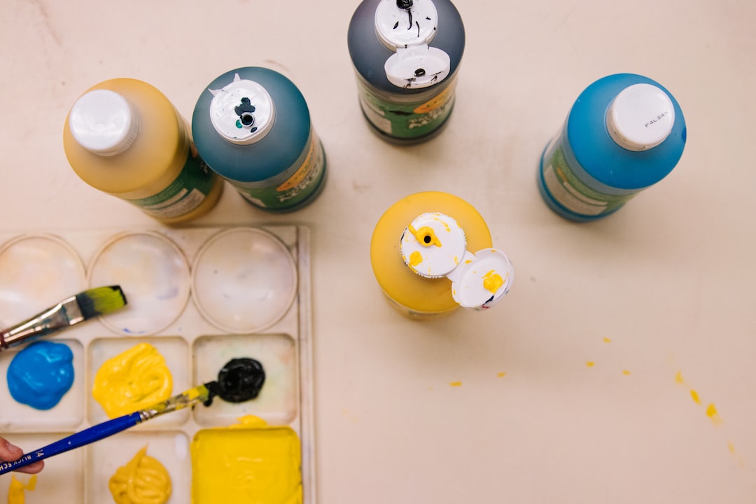 A group of paints and brushes on a table.