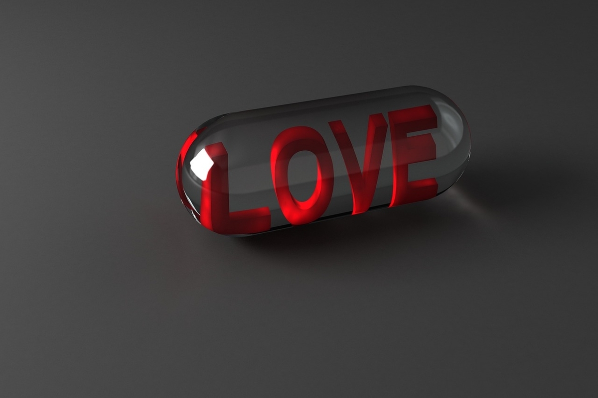 The word LOVE on a transparent capsule