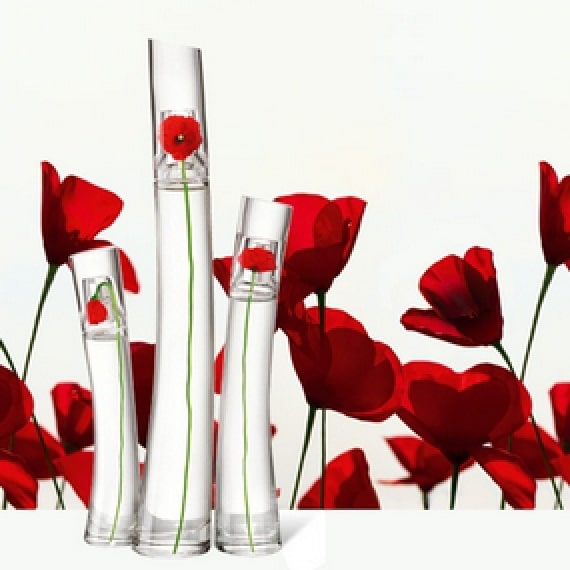 Three glass bottles with red flowers by Kenzo.