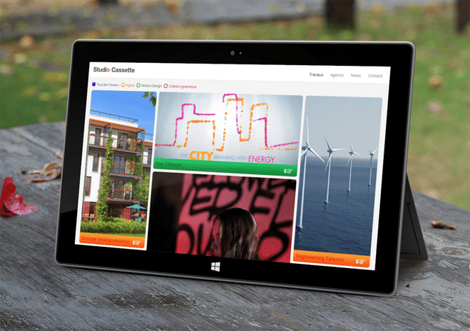 A tablet computer rests on a wooden table.