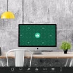 A computer with a green screen and a lamp on it.