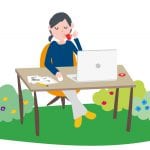 A woman sitting at a desk with a laptop.