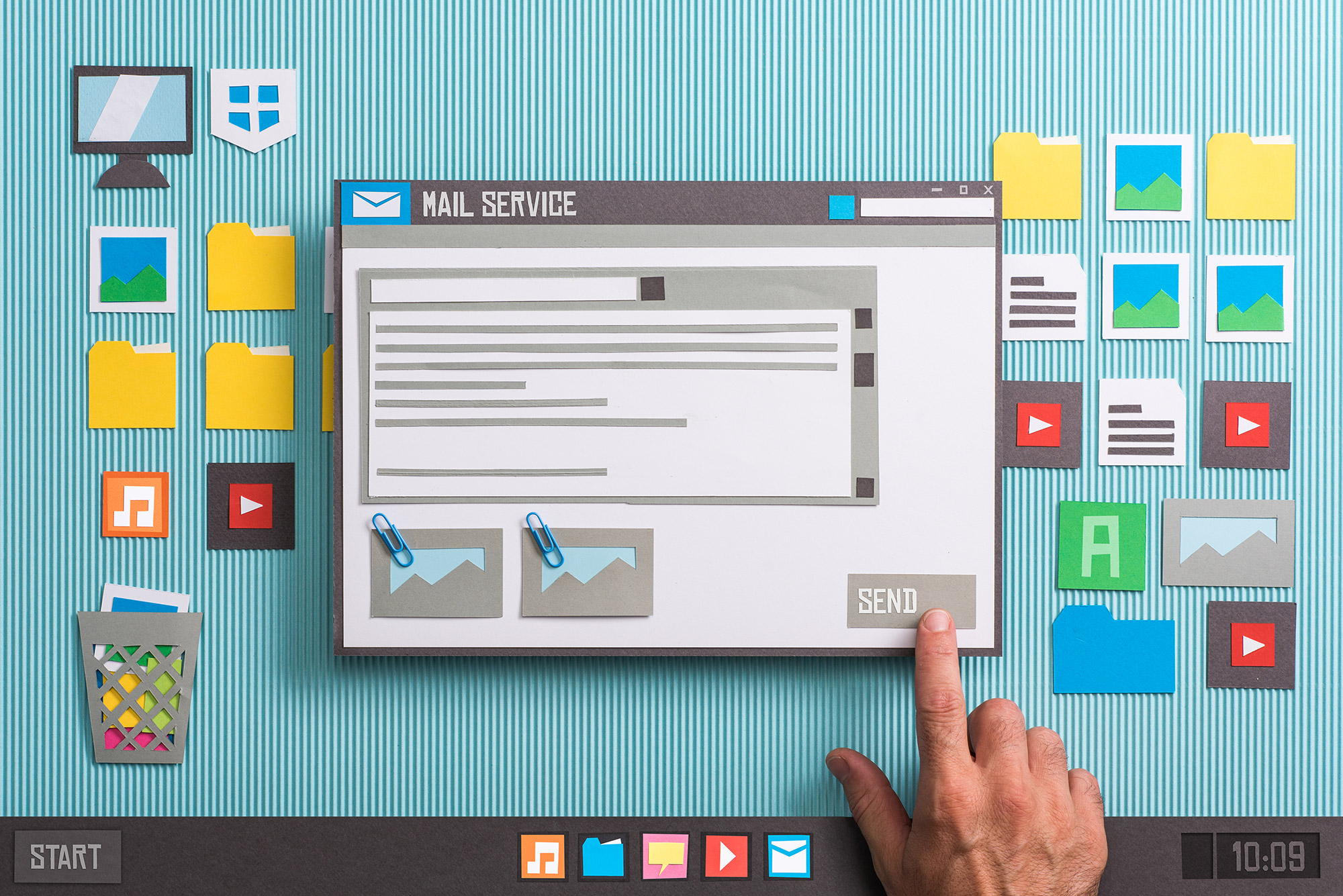 A hand points to a computer screen with many items on it.