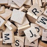 A stack of wooden scrabble tiles displaying letters for SEO.