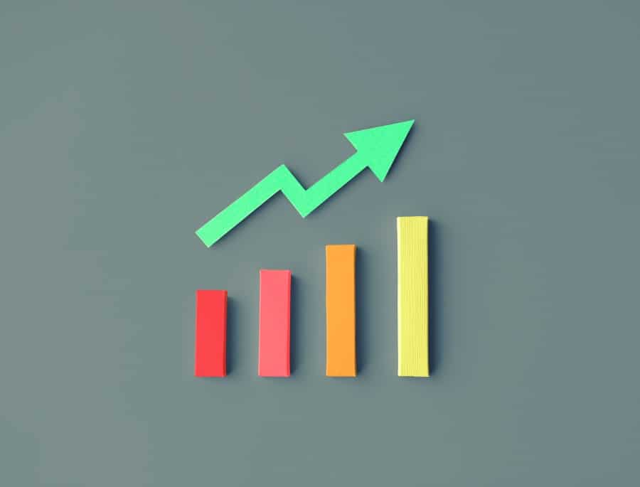 A colorful graphic with an arrow pointing upwards on a gray background.