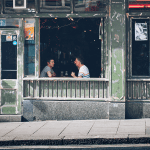 Two people having a drink at a local bar.