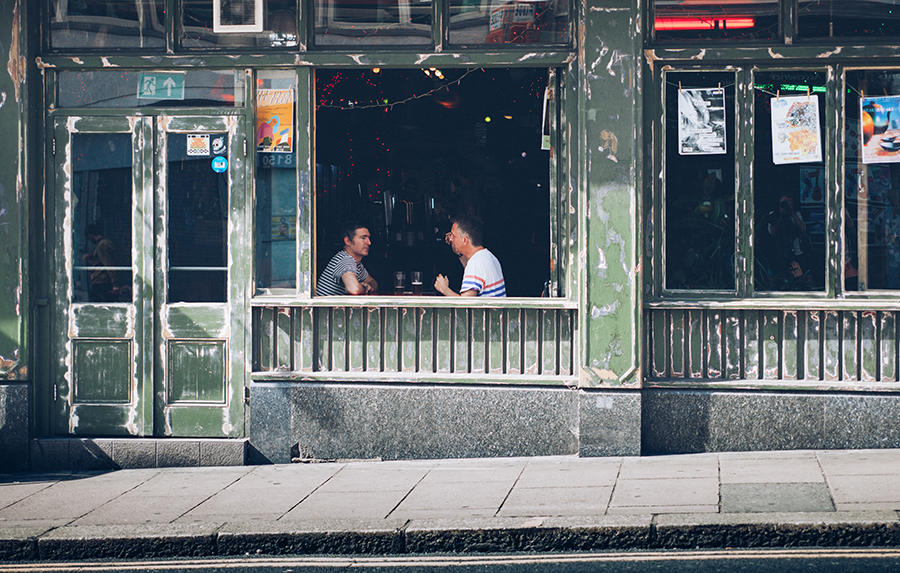 Two people having a drink at a local bar.