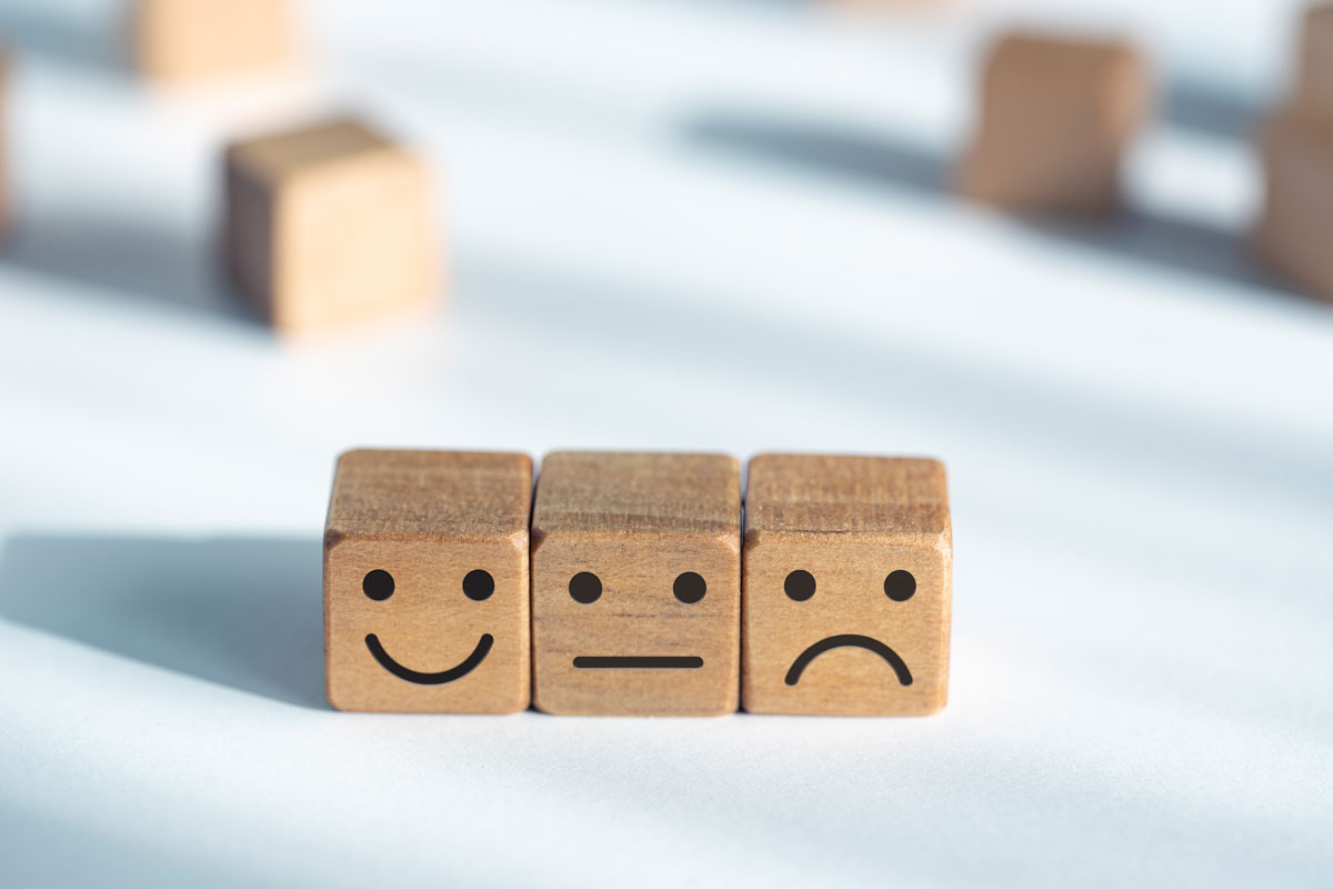 Three wooden cubes with smileys for sale on a Woocommerce platform.