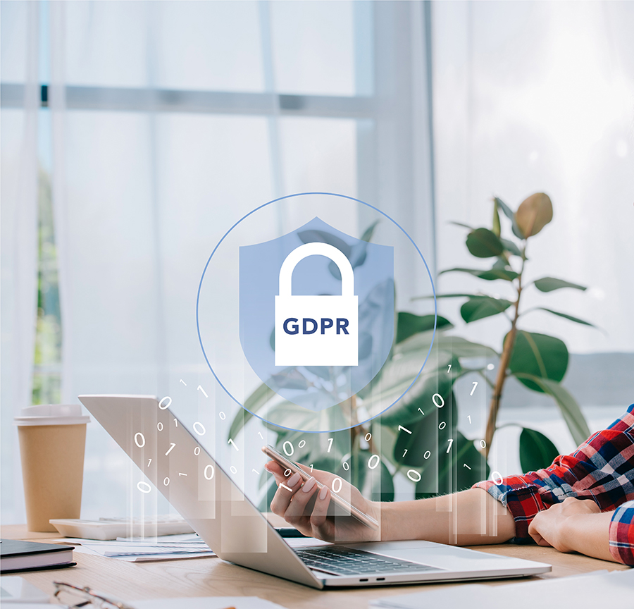 A woman participating in a workshop GDPR workshop using a laptop with the word GDPR on it.